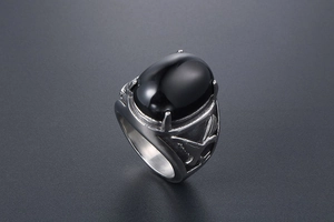 Macro shot of titanium steel ring with eagle relief and oval black agate gemstone