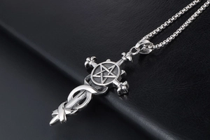 Detailed view of silver stainless steel gothic cross pendant with star design on black leather