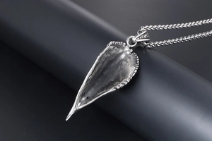 Detailed close-up of retro titanium steel eagle beak pendant with textured metal finish