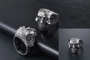 Macro detail of gothic skull ring with radial sun pattern on polished titanium steel