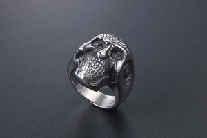 Macro side view of gothic skull ring showing detailed tribal engravings and oxidized metal finish