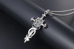 Macro view of gothic steel pendant featuring sword, cross, and pentagram details