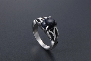 Detail of blue sandstone ring with hollow leaf patterns and silver stainless steel band