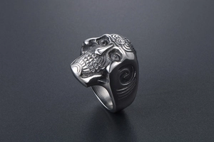 Macro detail of gothic skull ring featuring vintage texture and heavy punk metal carvings