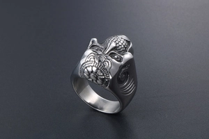 Macro shot of silver gothic skull ring with detailed punk animal relief engraving