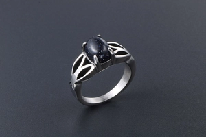 Detail showing vintage steel ring with blue sandstone inlay and hollow geometry