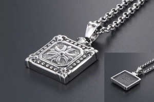 Macro view of square titanium steel pendant with cross relief and beaded edges