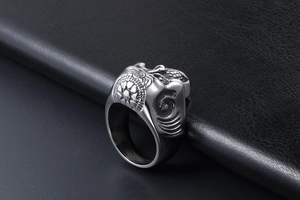 Macro side view of gothic skull ring with tribal relief patterns on black leather