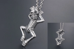Detailed view of gothic skeleton pendant with crown made of polished stainless steel