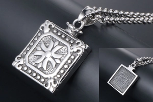 Macro detail of a square titanium steel pendant with embossed pattern and beaded chain