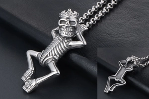 Detailed macro view of a vintage stainless steel skeleton pendant with crown on black leather