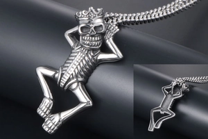 Macro shot of gothic crown skeleton pendant with vintage silver finish and thick chain