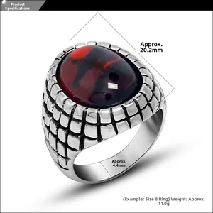 Macro view of vintage silver ring featuring red agate gemstone and mesh texture detail