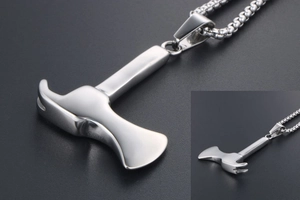 Macro shot of silver hammer pendant on a square link chain with polished finish