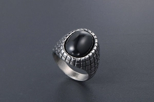 Detailed macro view of retro men's ring with black agate stone and engraved texture