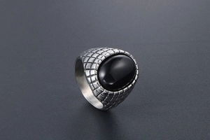 Macro view of vintage men's ring featuring black agate stone and dragon scale textures