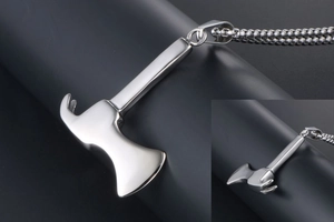 Detailed close-up of polished stainless steel axe pendant with matching bead chain necklace
