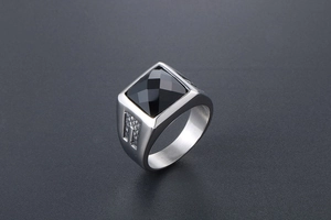 Macro view of vintage titanium ring featuring square black gemstone and textured metal band