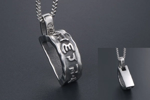 Macro view of religious mantra engraving on titanium steel pendant necklace for men