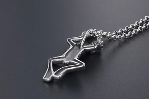 Macro side view of gothic silver skeleton pendant with crown detail on rolo chain necklace