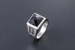 Detail of vintage silver titanium ring with square black gemstone and textured stone inlay