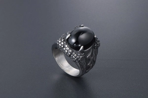 Macro detail of gothic dragon claw ring with large black oval gemstone in vintage finish