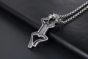 Macro shot of a silver gothic skeleton pendant on a stainless steel chain with black leather