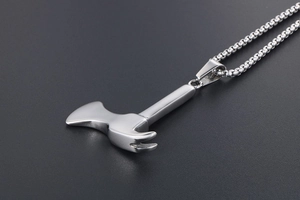 Detailed close-up of a silver axe and hammer tool pendant on a sleek bead chain