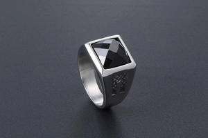 Macro detail of men's titanium ring with square multifaceted black gemstone inlay
