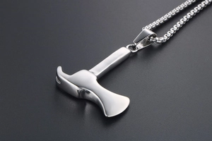 Macro shot of polished silver axe and hammer tool pendant necklace in stainless steel