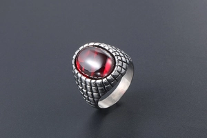 Detailed macro view of retro men's steel ring with a large oval red agate stone