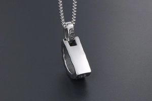 Close-up of titanium steel Om Mani Padme Hum pendant with gothic logo on box chain