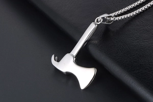 Macro shot of polished silver axe pendant in titanium steel with durable bead chain