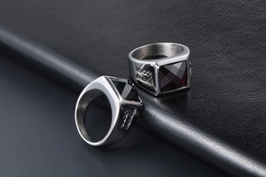 Detailed macro of stainless steel signet rings with red and black square gemstones