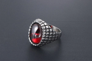 Macro side view of vintage men's ring with oval red gemstone and textured scales
