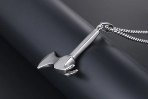 Macro shot of polished silver hammer pendant with round bead chain accessory