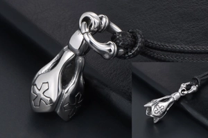 Macro detail of gothic lotus cross pendant in titanium steel with black woven rope