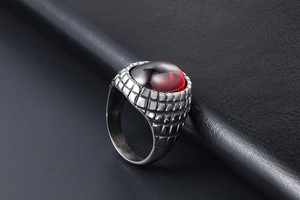 Detailed side view of vintage men's ring with red gemstone and silver textured band