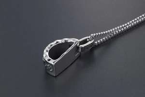Macro shot of the square chain and silver-toned religious mantra pendant necklace