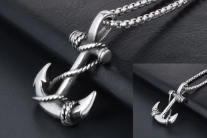 Macro detail of vintage silver anchor pendant with rope texture and steel box chain