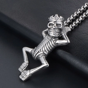 Gothic punk silver skeleton pendant with crown on black leather background