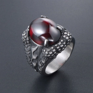 Gothic dragon claw ring for men featuring a large red gemstone and dragon scale textures