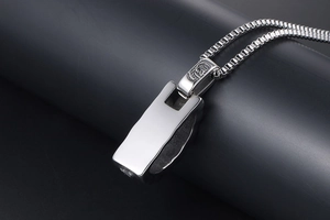 Macro shot of titanium steel rectangle pendant with Gothic engraving on the bail