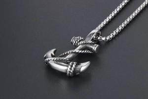 Close-up of vintage anchor pendant with rope detail on a stainless steel box chain
