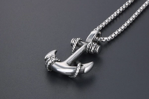 Macro shot of vintage anchor pendant with detailed rope texture on steel box chain