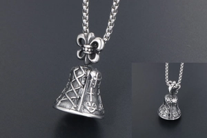 Macro view showing vintage bell pendant with fleur-de-lis and cross motifs in aged steel