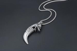 Macro detail of retro wolf tooth pendant with silver metal texture and punk style carving