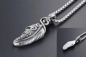Detailed view of stainless steel feather pendant with intricate carving and box chain