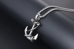 Detail of vintage anchor pendant with rope texture and stainless steel box chain
