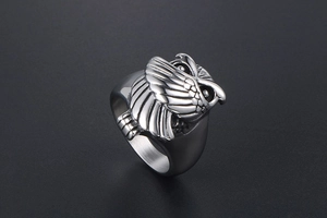 Détail d'une bague rétro en acier titane avec motif de hibou en relief et plumes ciselées